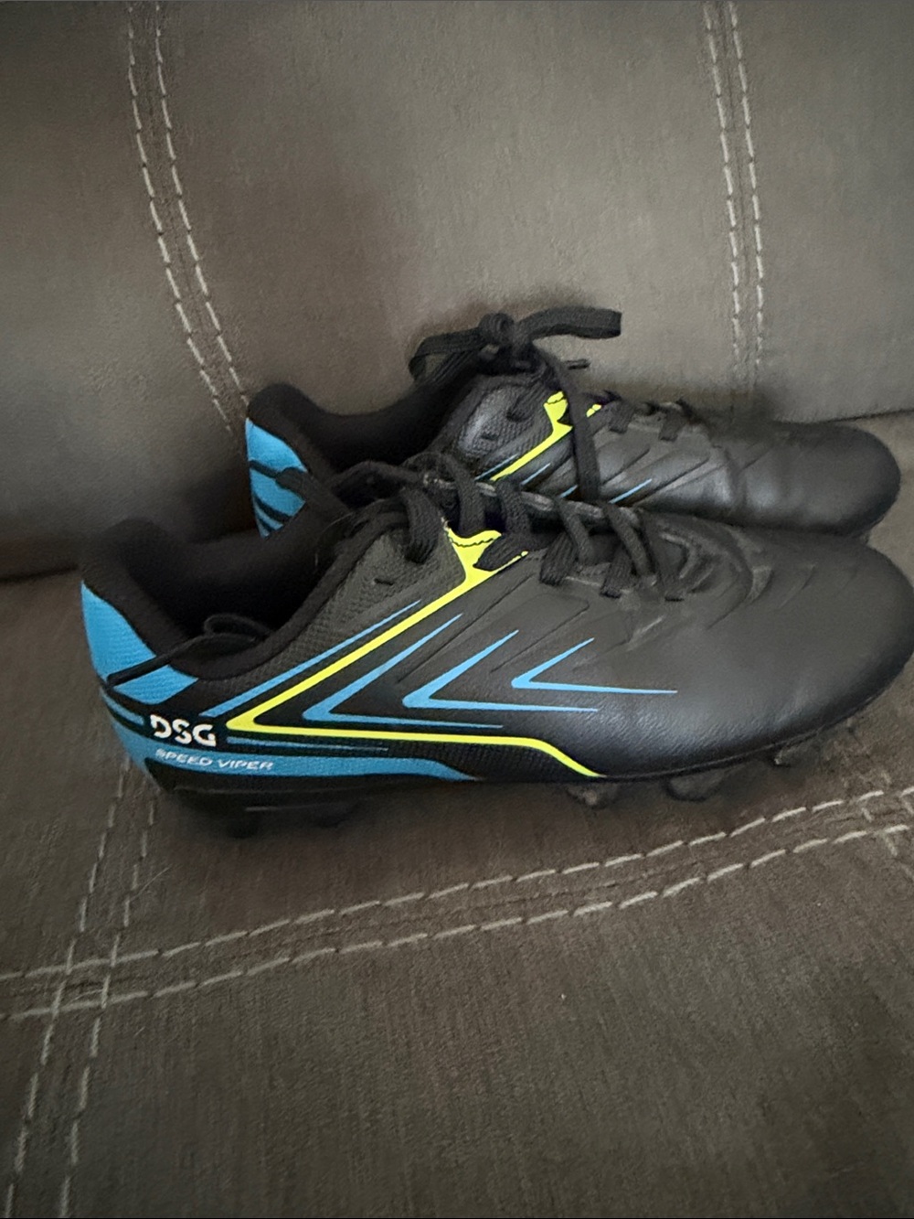 DSG Kids Black  Cleats with Blue & Yellow Accents